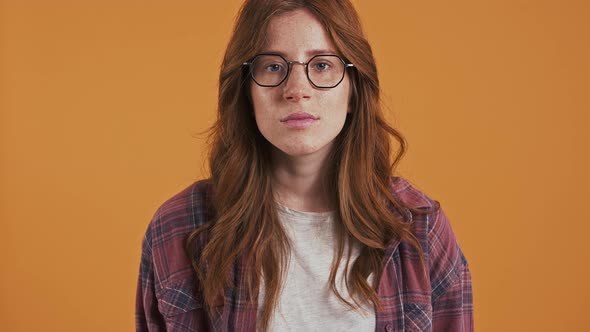 Ginger Teenage Female in Checkered Shirt and Glasses