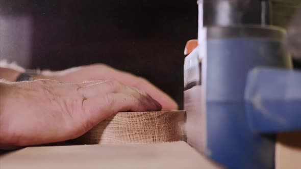 Craftsman Working with Grinding Machine at Wood Workshop, Hands Closeup.