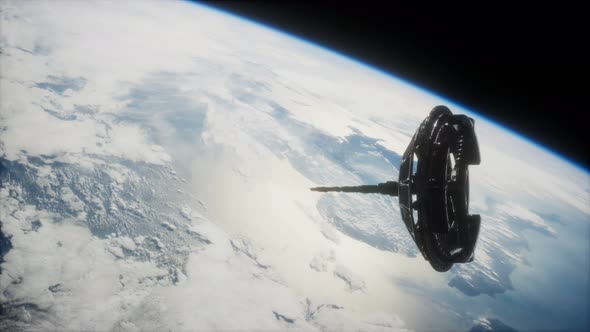 Futuristic Space Satellite Orbiting the Earth alt