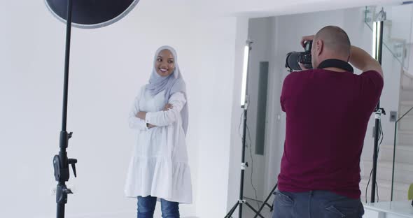 Photographer in Photo Studio Shooting Traditional Muslim Black Model