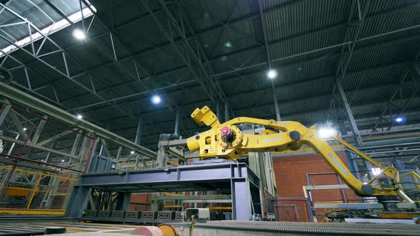 Mechanical Robotic Arm Is Relocating Brick Blocks at Industrial Plant