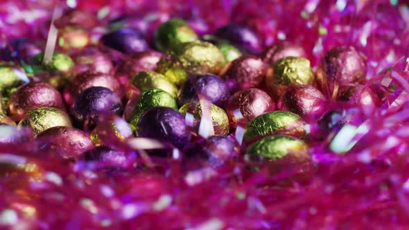 Rotating shot of colorful Easter candies on a bed of easter grass