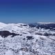 Aerial drone of an amazing panoramic view of a mountain range covered with snow during a sunny day - VideoHive Item for Sale
