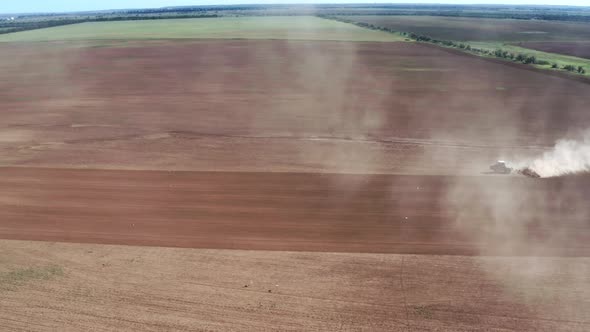 Aerial View to Tractor Plowing Field