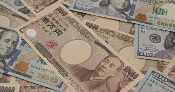 Stack of Japanese yen and USD