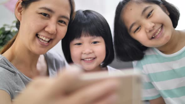 Slow motion Happiness moment at home, Happy Asian family take selfie photo together.