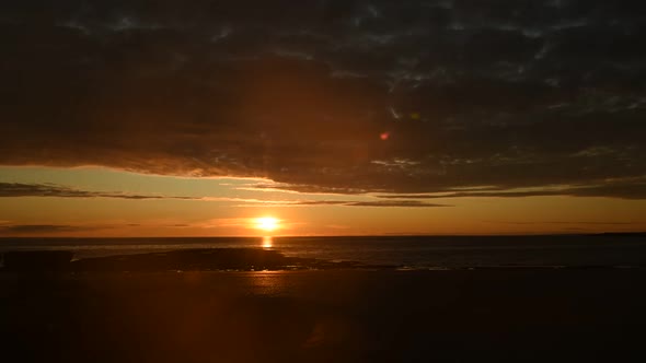 Time lapse of dramatic sunset over beach