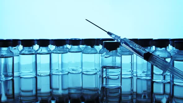 Vaccine bottles and syringe injection. Medicine in ampoules.