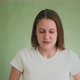 Aggressive Woman Clutches Head Posing for Camera on Green - VideoHive Item for Sale