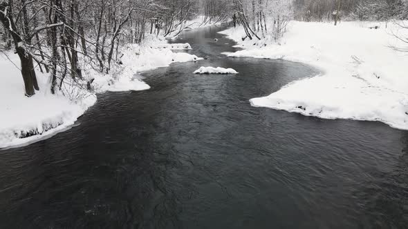 New Year's Snowy Fantastic Landscape with a Nonfreezing River Aerial View