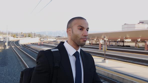 Businessman in a suit waits for a train