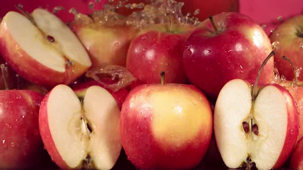 Slow Motion Shot of Red Apple Juice Splashing Through Apple Slices