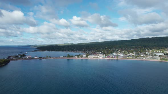 Drone fly over of a boat harbor on a partly cloud summer day