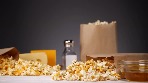 Crop Person Taking Popcorn From Table