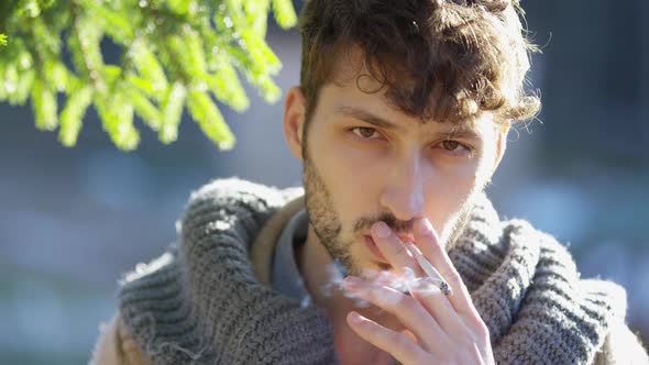 Close up of a young man smoking