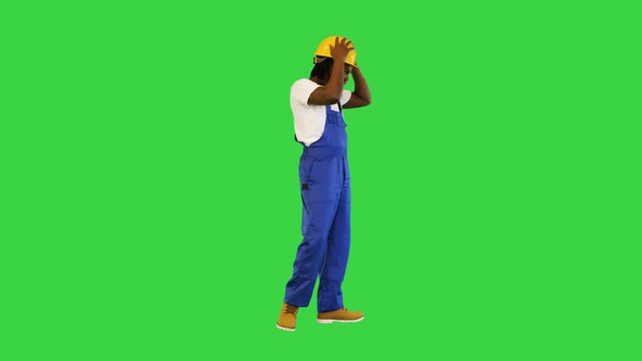 Young Handsome African American Worker Man Wearing Blue Uniform and Security Helmet Changing Poses