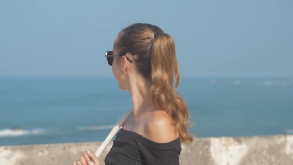 Woman Walks Along Sea Fort Enjoying Surrounding Landscape