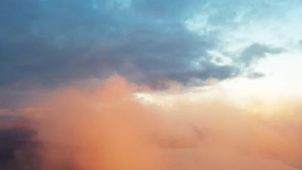 Aerial clouds to the sky in motion. Aerial view white clouds in blue sky during sunrise or sunset. 