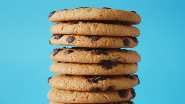 A Stack Chocolate Chip Cookies Rotate on a Blue Background