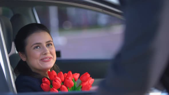 Boyfriend Opening Car Door for Smiling Woman With Bunch of Tulips, Romance