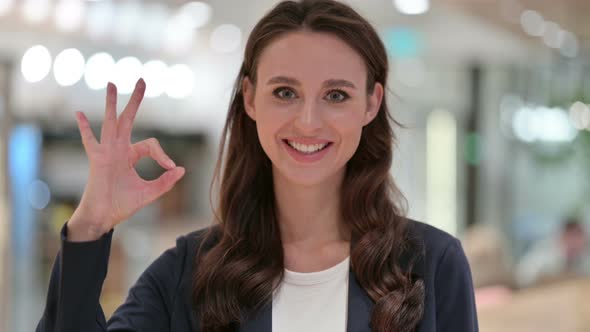 Portrait of Appreciative Businesswoman with OK Sign By Hand 