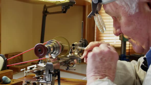 Horologist repairing a watch