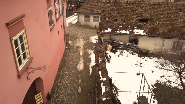 Beautiful view of the colorful houses and the old stone paved streets with some snow in the medieval