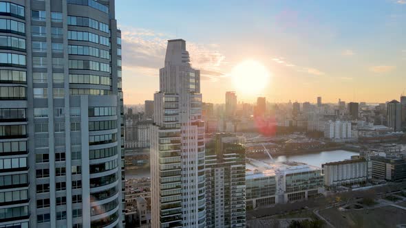 4K Aerial Drone Footage Flying Past Modern Construction Apartments Revealing Cityview During Sunset