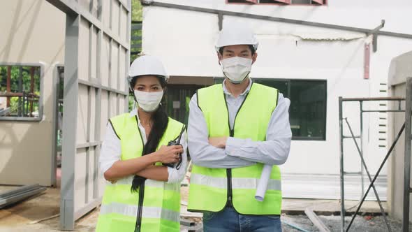 Portrait of Asian worker people wear protective mask onsite of architecture due to covid19 pandemic.