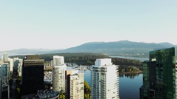 aerial drone footage of downtown Vancouver buildings and a beautiful view of Stanley Park. (British