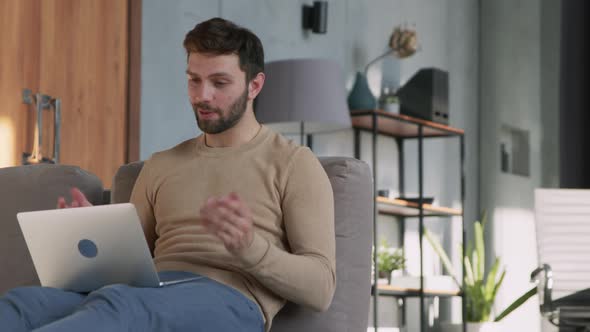 Attractive man conducting video conversation