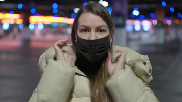 Young Woman in a Protective Black Mask on Her Face