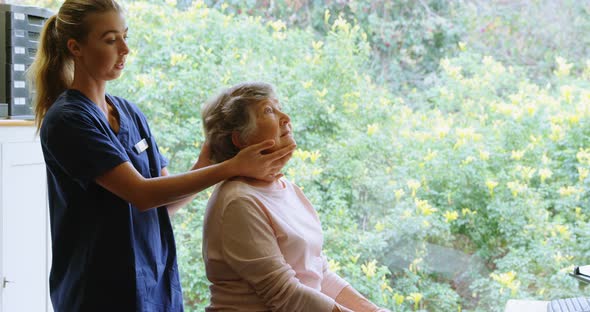 Physiotherapist giving neck therapy to senior woman 4k