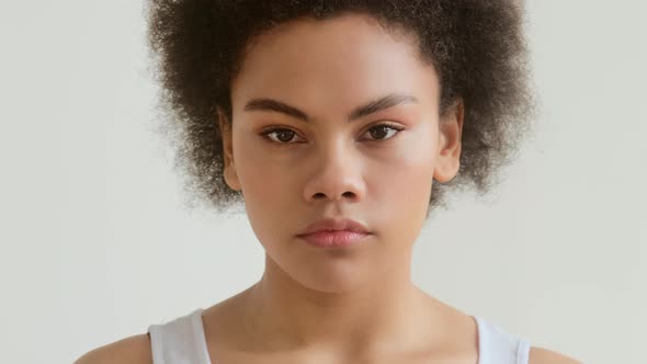 Portrait of serious African American woman looking at camera. Real people