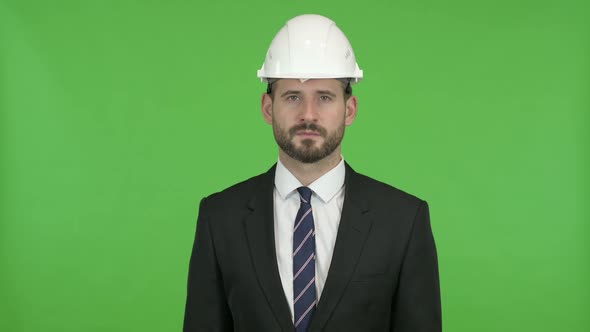 Young Engineer Looking in Camera Against Chroma Key