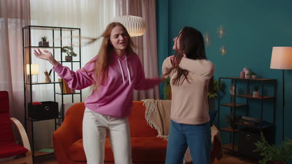 Happy Two Teenage Girls Siblings or Bloggers Couple Dancing at Home Having Fun Enjoying Trendy Dance