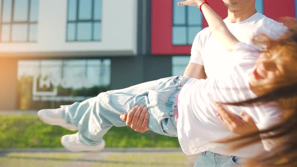 Father Circling His Daughter in His Arms