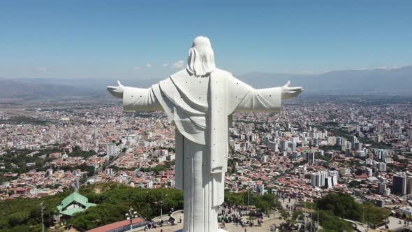 Cristo de la Concordia Jesus statue in bolivia pull back aerial reveal over city