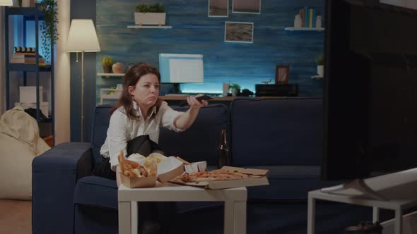 Woman Relaxing on Couch with Takeaway Food at Home