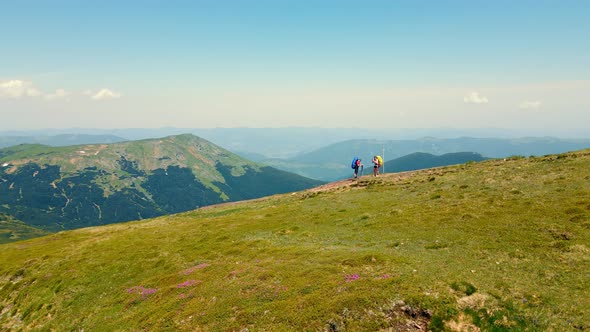 Two Tourists are Standing on the Montenegrin Ridge