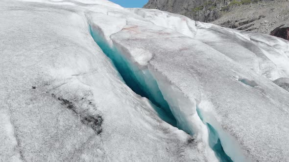 Aerial: beautiful glacier ice formation in frozen mountain alpine landscape