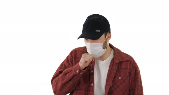 Adult Farmer in a Medical Mask Coughing While Walking on White Background