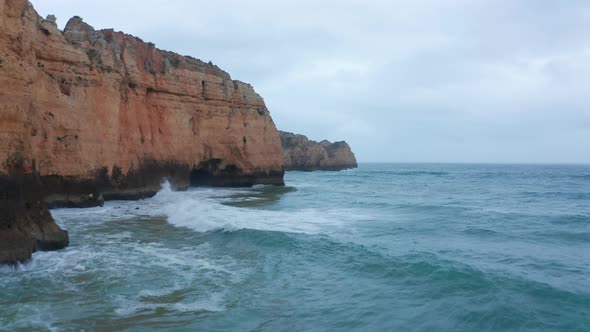 Scenic Background Banner Aerial Drone View of Lagos Coastline with Waves Crashing Against Cliffs on