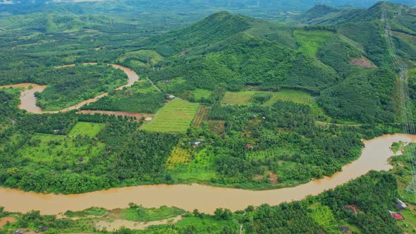 4K : Aerial view over farmland and hill farming