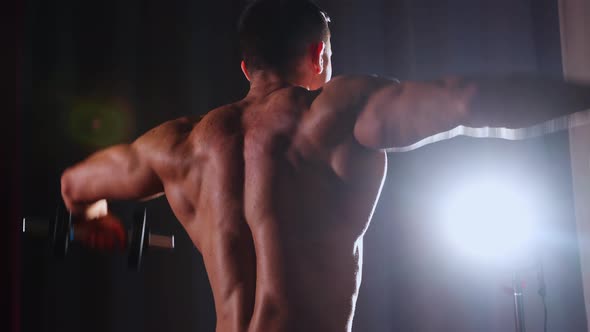 Sports Training  Athletic Muscular Shirtless Man Training His Hands  View From the Back
