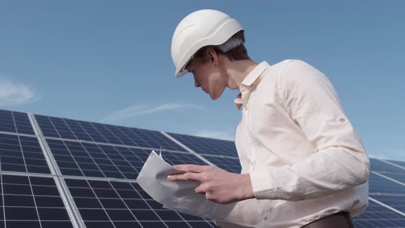 A Man Is Checking the Solar Power Panel at the Plant