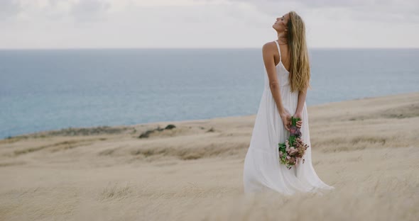 A beautiful woman in a flowing white dress