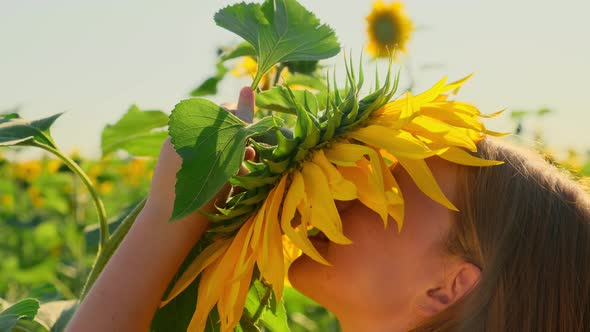 Girl Playing and Having Fun in a Sunflower Field