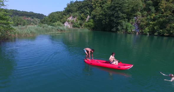 Man doing backflip from a canoe on Mreznica river, Croatia