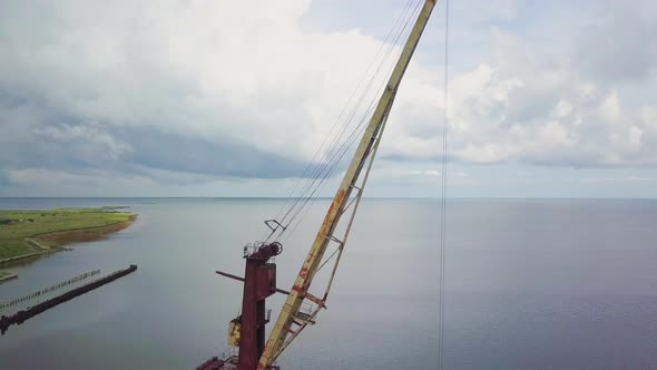 An Old Abandoned Rusty Crane in the Seaport